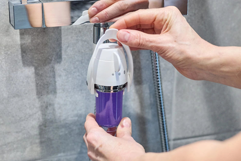 Person replacing a Soap Shower refill into the dispenser